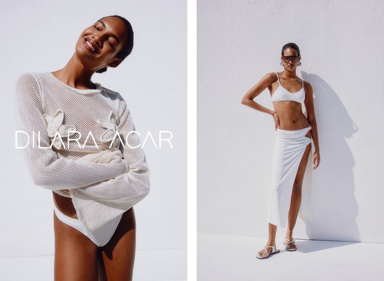 Nenna Nwosu, modelo internacional representada por Be Management, posando contra uma parede branca iluminada pelo sol com top de biquíni branco e saia branca com fenda alta.